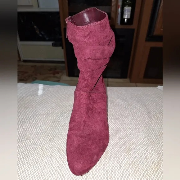 A pair of Kaari Blues Kensie burgundy booties in a ladies size 8.5.