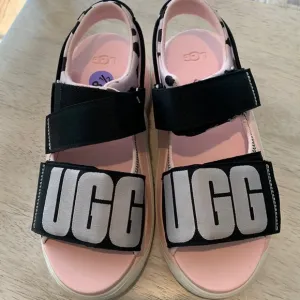 Ugg pink and black sandals “treadlite by Ugg” New without Tags size 8-1/2.